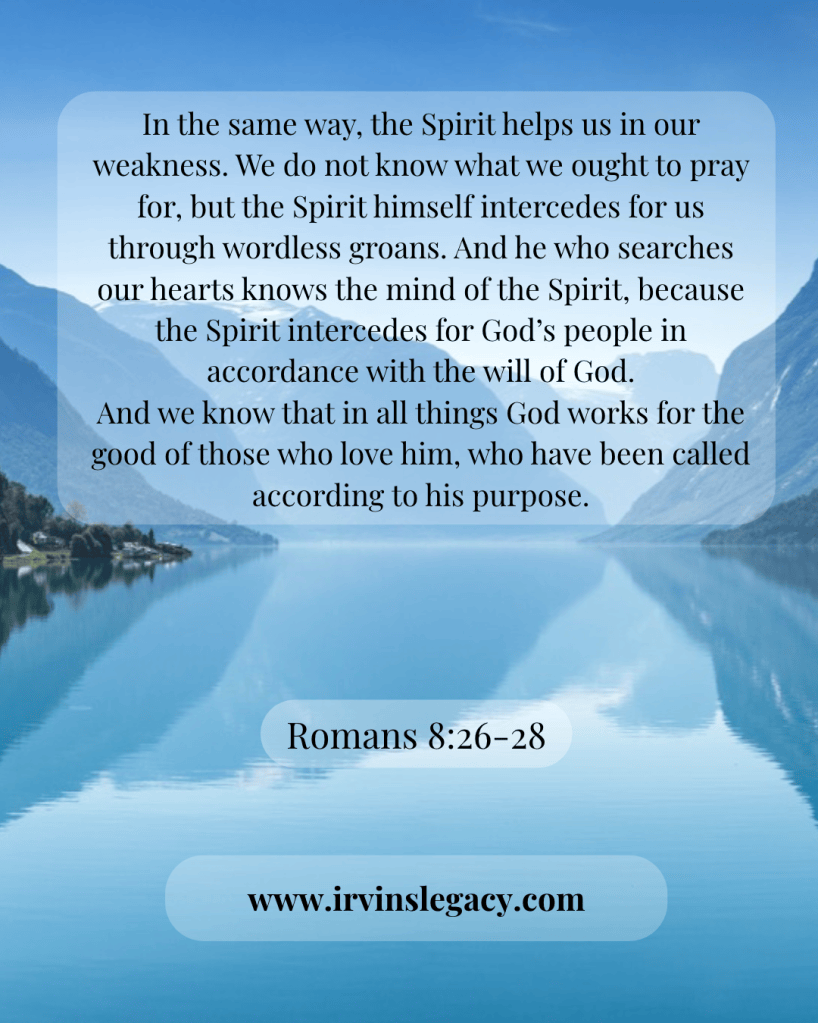 A serene lake with mountains in the background, featuring an overlay of a biblical passage from Romans 8:26-28 and a website URL.